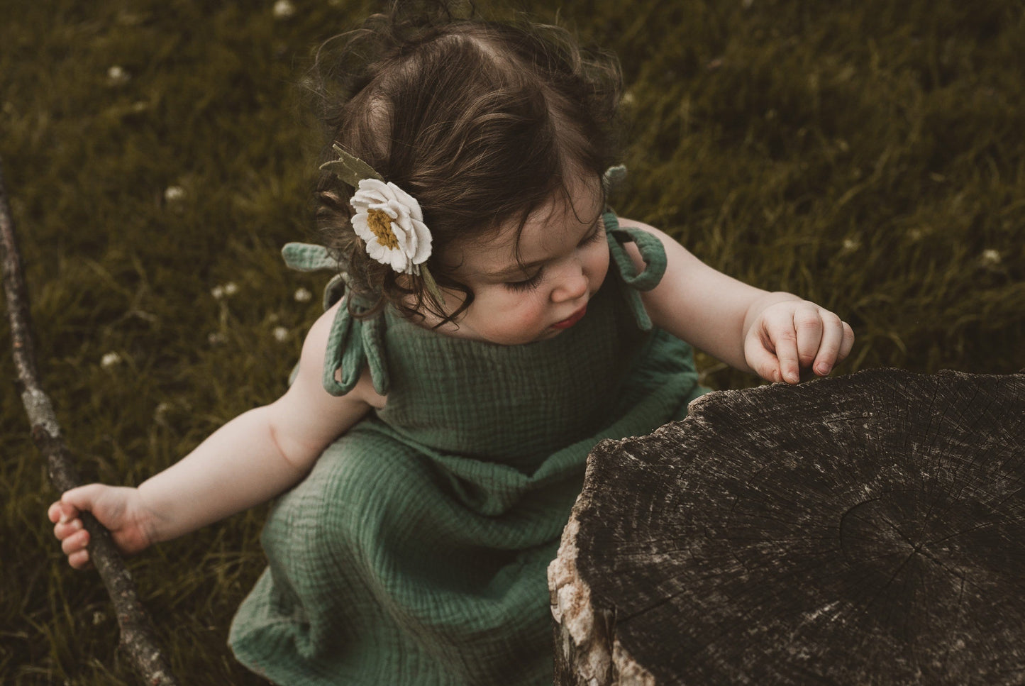 girl stood in garden in summer wearing a double gauze dress in forest green adjustable straps sustainable bohemian hippy beach clothing