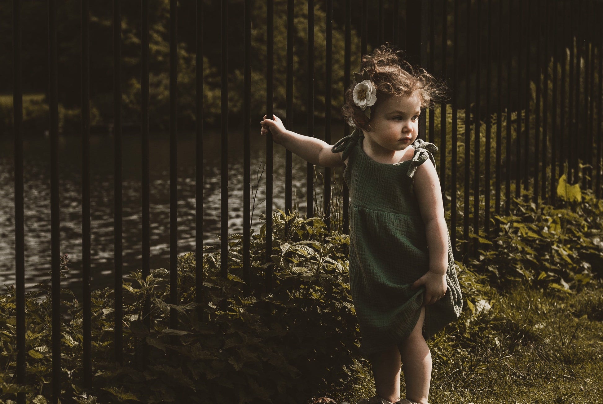 girl stood in garden in summer wearing a double gauze dress in forest green adjustable straps sustainable bohemian hippy beach clothing