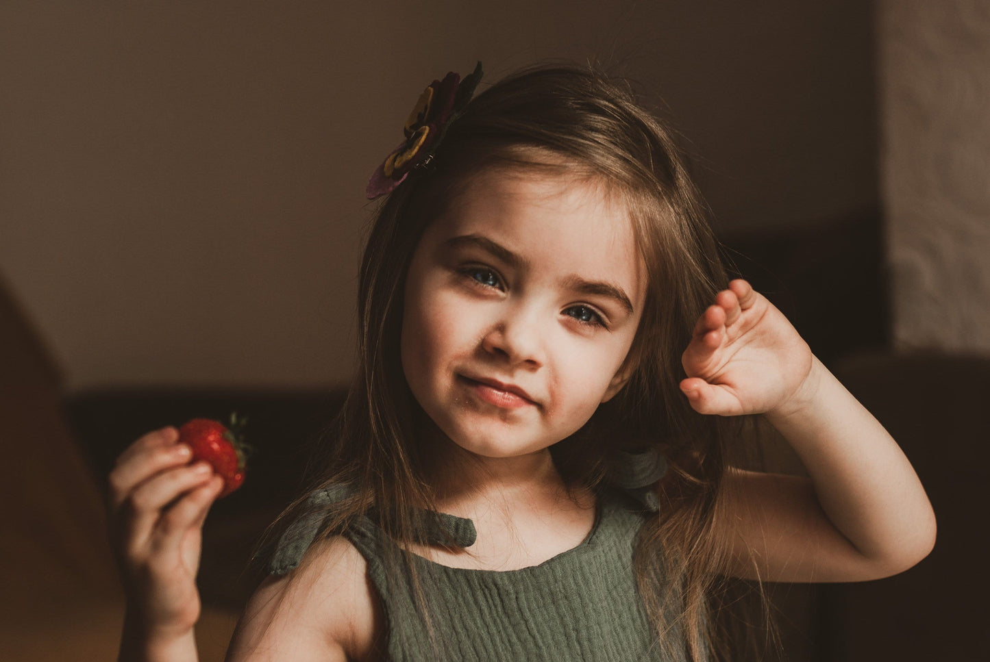 baby toddler girl smiling in her bedroom wearing a double gauze dress in forest green adjustable straps sustainable bohemian hippy beach clothing